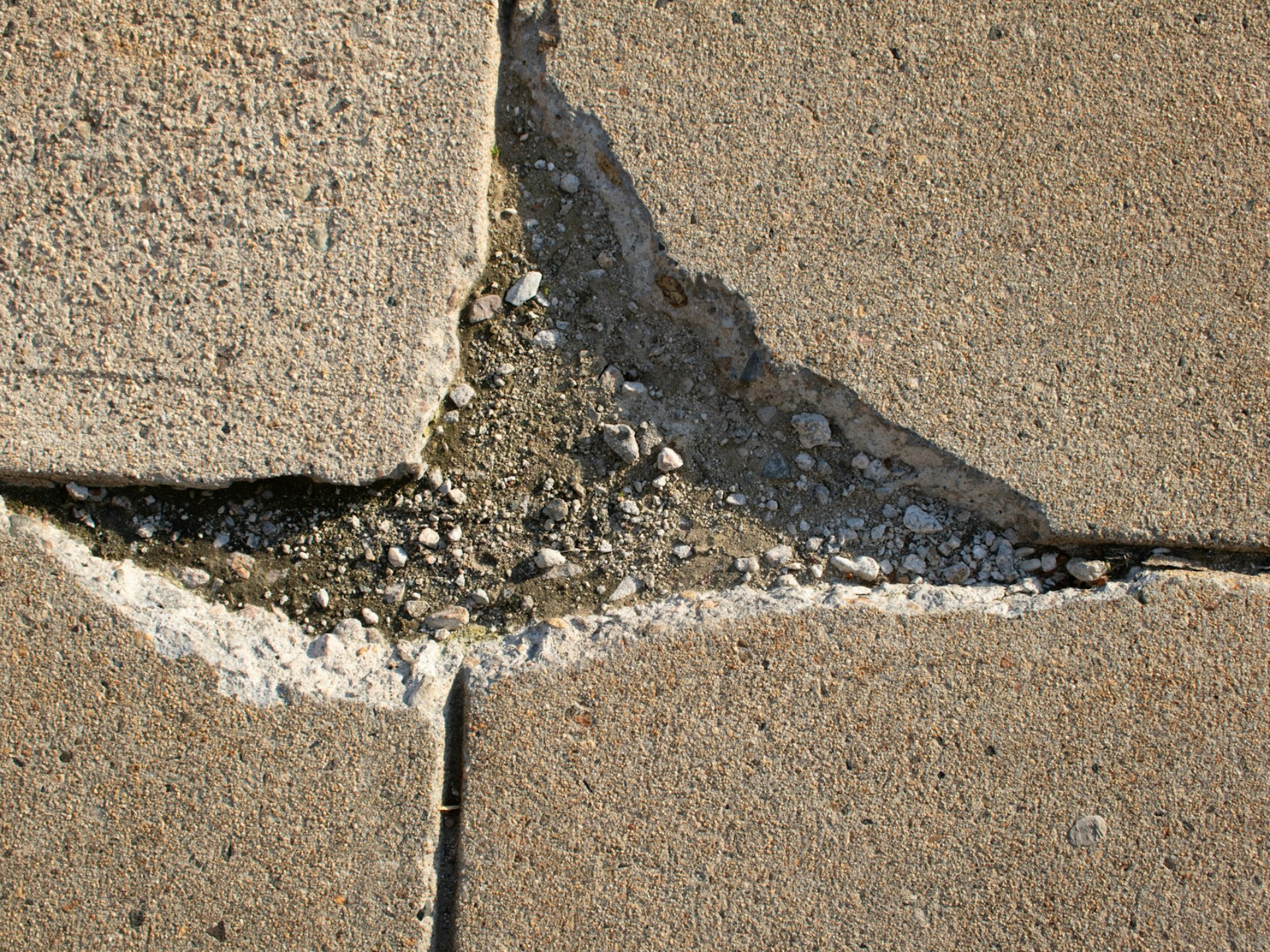 a crack in a concrete wall with a white line going through it